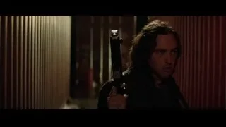 man holding gun in dimly lit room — Batman