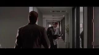 Man in suit walking office corridor — American Psycho