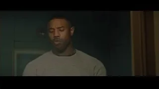 young man in grey t-shirt in dimly lit room — Creed 2