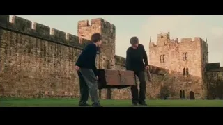 Two young men examining chest by castle — Harry Potter and the Philosophers Stone