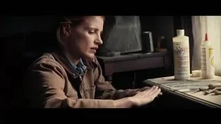 young woman deep in thought holding object — Interstellar