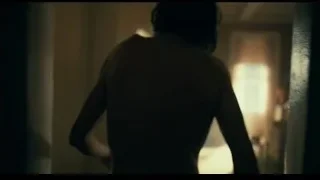 Man with back to camera holding cigarette — Joker