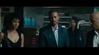 Three people conversing in dimly lit room — Furious Seven