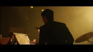 man in black suit playing drums — Whiplash