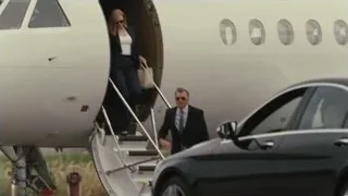 People walking up airplane stairs — Succession