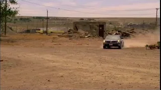 Car driving on a dirt road with dust cloud — Breaking Bad