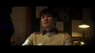 Man in suit by fireplace with Melby Millinery sign — Bruce Lee: Birth of The Dragon