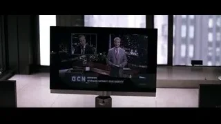 TV screen showing news anchor with city skyline — Batman: The Dark Knight