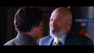 Two men in tense confrontation, one holding gun — Iron Man