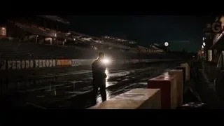 Man walking on wet track at night — Ford v Ferrari