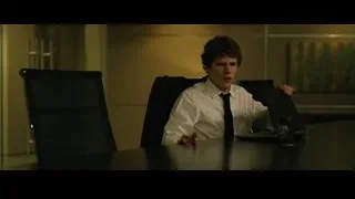 young man sitting at office desk with laptop — The Social Network