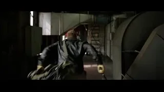 person walking in industrial hallway — Batman: The Dark Knight