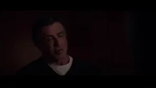 man's serious face in dark room — Creed