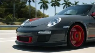black Porsche 911 GT3 RS driving on road — Sports Cars