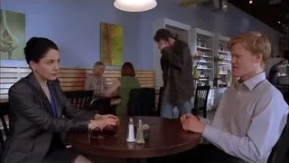 People conversing at wooden table in restaurant — Breaking Bad