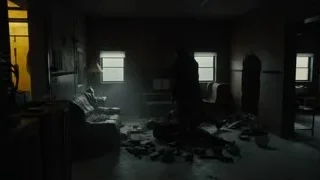 person walking in abandoned room with debris — Blade Runner 2049