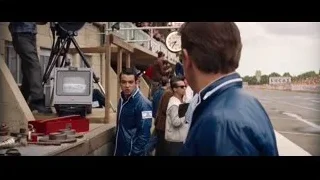 man in blue jacket at race track — Ford v Ferrari