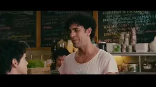 man with curly hair by blackboard menu — The Dictator