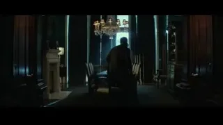 two men standing by fireplace in dining room — John Wick