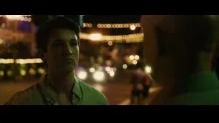 Young man in green shirt on busy street at night — Whiplash