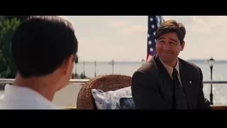 Men conversing on balcony overlooking marina — The Wolf Of Wall Street