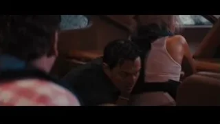 man with glasses in dimly lit room — The Wolf Of Wall Street