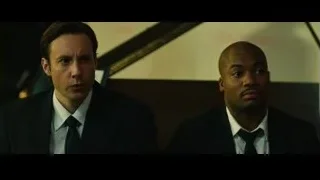 Two men in suits on staircase — Whiplash