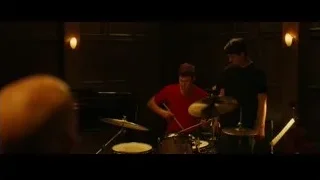 two young men playing drums in dimly lit room — Whiplash