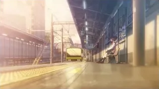 Person waiting for yellow train on platform — Your Name
