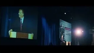 two men in suits conversing in dimly lit room — The Big Short