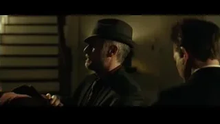 two men in suits in dimly lit room — John Wick
