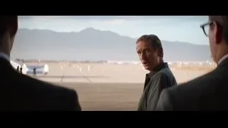 three men in desert with mountains and airplanes — Ford v Ferrari