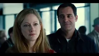man and woman standing in room with windows — Jurassic World