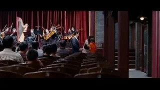 Musicians performing on auditorium stage — The Karate Kid