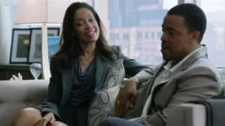 Man and woman smiling on couch — Suits