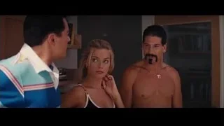 three people in room with bookshelf — The Wolf Of Wall Street