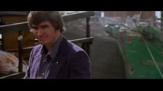 man standing by green boat in harbor — Bruce Lee: Enter The Dragon
