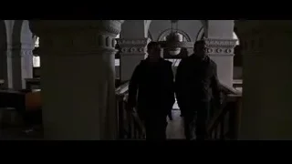 men walking through dimly lit room with arches — Batman: The Dark Knight Rises