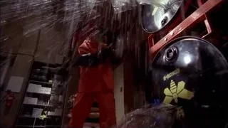 person in red suit spraying radioactive drum — Breaking Bad