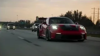 Red sports car driving on highway at sunset — Sports Cars