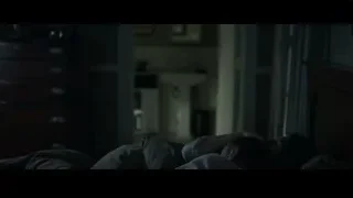 man sitting on bed talking on phone — The Social Network