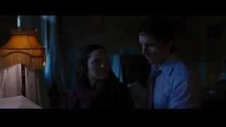 Man and woman in dimly lit room — Batman: The Dark Knight Rises