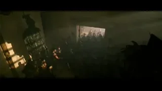 people in dimly lit room with warrior statue — Gladiator 2