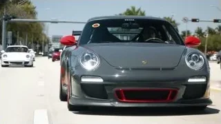black Porsche driving on track — Sports Cars