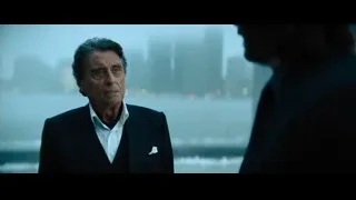 man in suit in front of city skyline — John Wick: Chapter 4