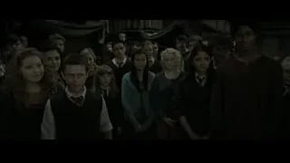 Group of formally dressed people in dimly lit room — Harry Potter and the Deathly Hallows 2