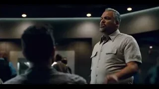 two men facing each other in dim room — Jurassic World