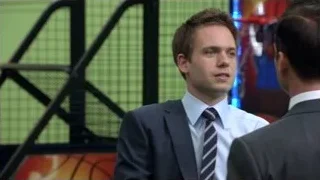 Two men in suits by green wall — Suits