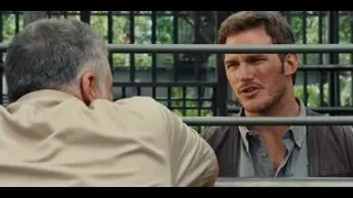 two men talking on park bench — Jurassic World
