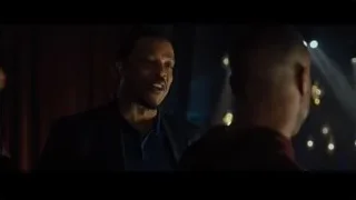 two men facing each other in a dimly lit room — Creed 2